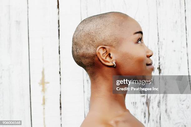 profile of naked bald black woman - cancer portrait stock-fotos und bilder