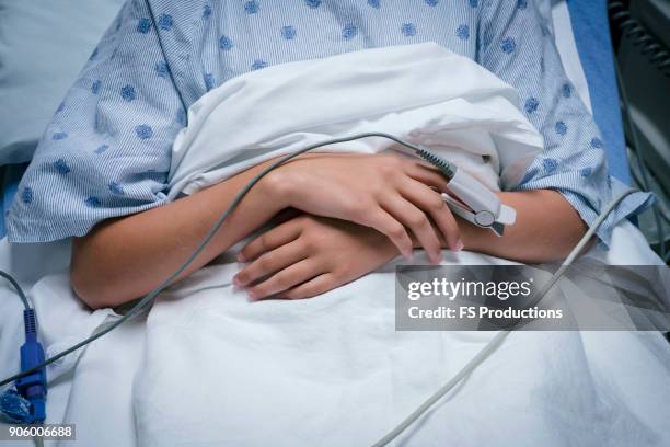 monitor on finger of caucasian girl in hospital - girl in hospital bed sick stock pictures, royalty-free photos & images