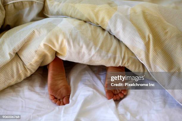 feet of caucasian boy under blanket - pixelchrome inc stock pictures, royalty-free photos & images