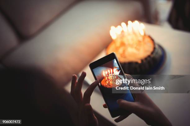 mixed race girl photographing birthday cake with cell phone - an unforgettable evening stock pictures, royalty-free photos & images