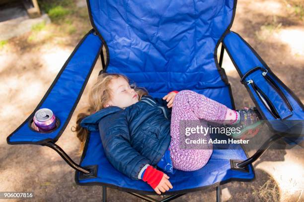 Caucasian girl sleeping on folding chair