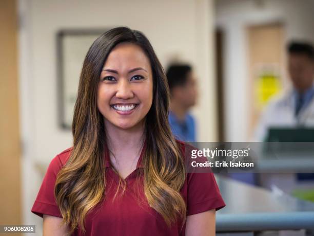 portrait of smiling nurse in hospital - filipino ethnicity foto e immagini stock