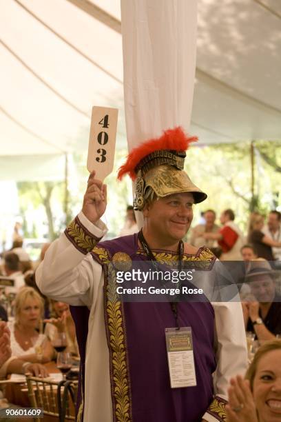 Rob Irwin, dressed in a Roman costume, holds his paddle up during the 17th Annual Sonoma Valley Harvest Wine Auction as seen in this 2009 Sonoma,...
