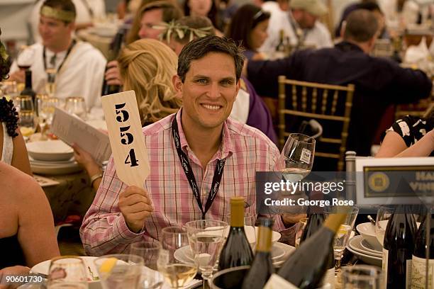 Vineyard owner Ben Sharp holds up his paddle during the 17th Annual Sonoma Valley Harvest Wine Auction as seen in this 2009 Sonoma, California,...