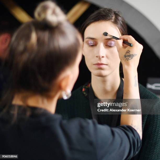 Model gets prepared ahead of the Lena Hoschek Fashion Show Berlin at Botanischer Garten on January 16, 2018 in Berlin, Germany.