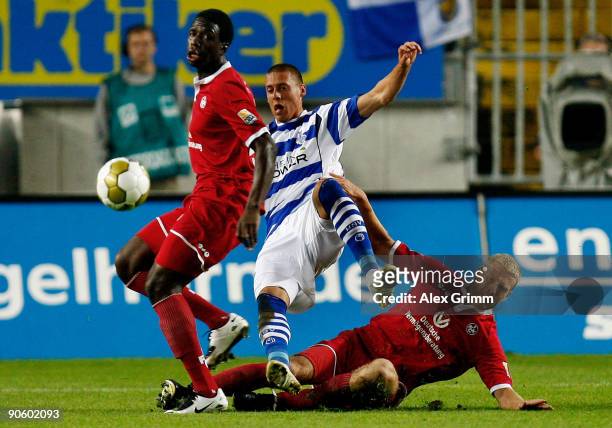 Sandro Wagner of Duisburg is challenged by Georges Mandjeck and Adam Nemec of Kaiserslautern during the Second Bundesliga match between 1. FC...