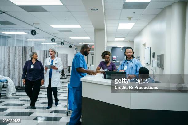 doctors and nurses in hospital - accident hospital stock pictures, royalty-free photos & images