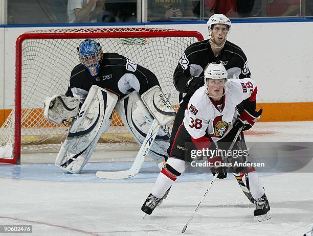 Erik Condra of the Ottawa Senators waits to deflect a shot in front of goaltender Michael Hutchinson of the Boston Bruins in a game in the NHL Rookie...