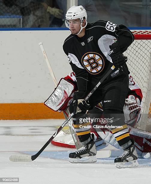 Tyler Randell of the Boston Bruins skates near the crease area to deflect a shot during a game against the Ottawa Senators in the NHL Rookie...