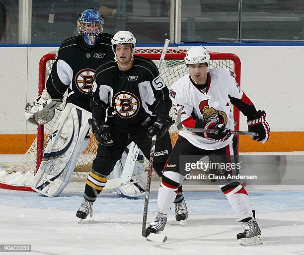 Keegan Dansereaux of the Ottawa Senators waits to deflect a shot in front of Mark Isherwood of the Boston Bruins in a game in the NHL Rookie...