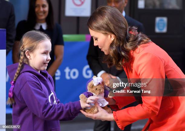 Ava Watt, aged 9 with Cystic fibrosis, presents Catherine, Duchess of Cambridge with teddy bears during her visit to Great Ormond Street on January...