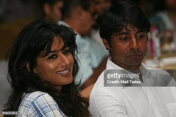 Golfer Jyoti Randhawa looks pensive as his actress-wife Chitrangada Singh smiles at 'Walking On Broken Das', a stand-up comedy act by Vir Das, at...
