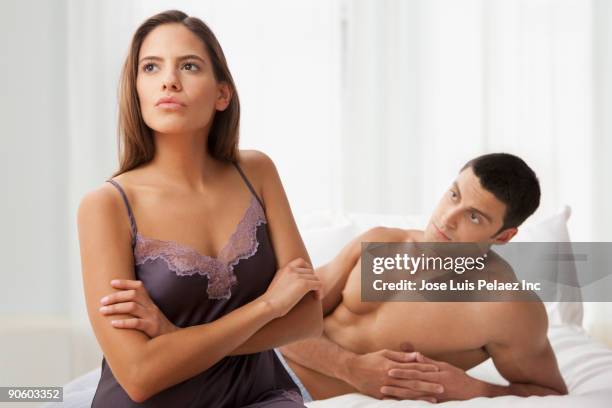 unhappy couple in bedroom - weigeren stockfoto's en -beelden