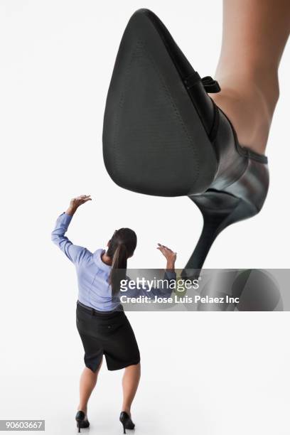large high heel looming over businesswoman - big foot 個照片及圖片檔