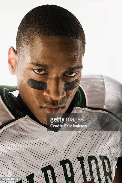 african football player with face paint under eyes - eye black stockfoto's en -beelden