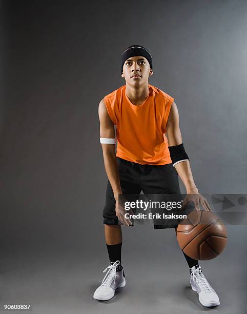 mixed race basketball player dribbling basketball - sólo-una-adolescente fotografías e imágenes de stock