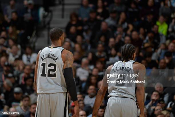 LaMarcus Aldridge and Kawhi Leonard of the San Antonio Spurs stand on the court during the game against the Denver Nuggets on January 13, 2018 at the...