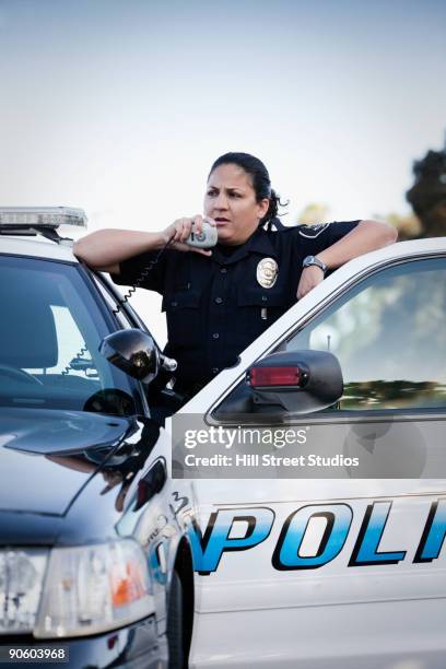 hispanic policewoman talking on cb radio - police woman stock pictures, royalty-free photos & images