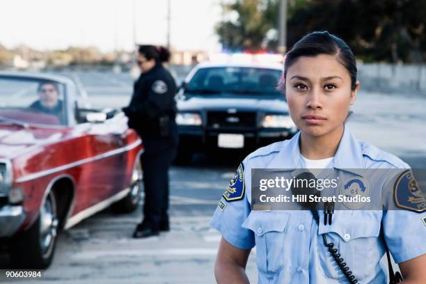 policewomen pulling over man in convertible - police woman stock pictures, royalty-free photos & images