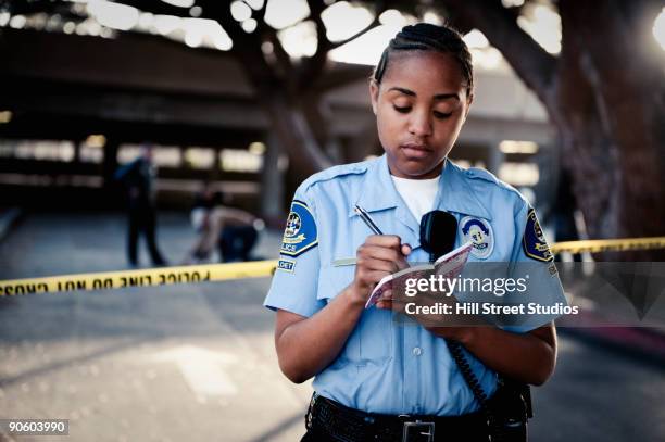 african policewoman writing in notebook - cadete fotografías e imágenes de stock