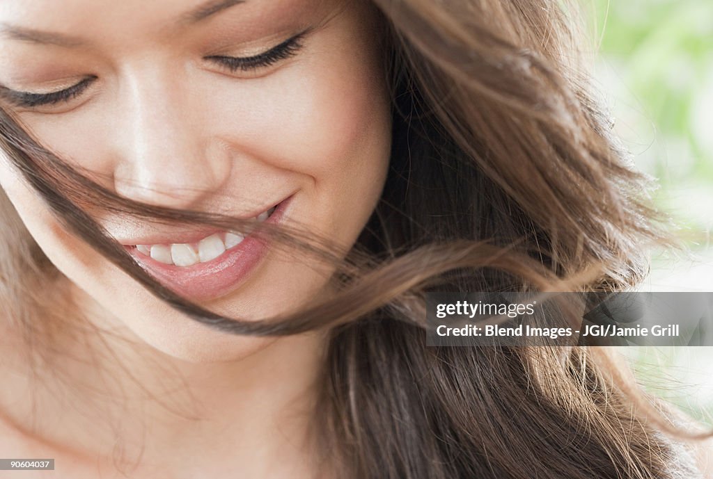 Mixed race woman looking down and smiling