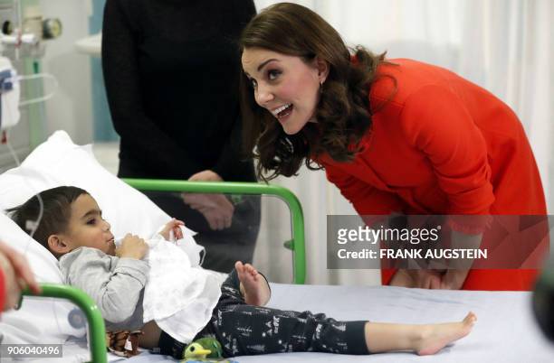 Britain's Catherine, Duchess of Cambridge interacts with patient Rafael Chana during her visit to officially open the Mittal Children's Medical...