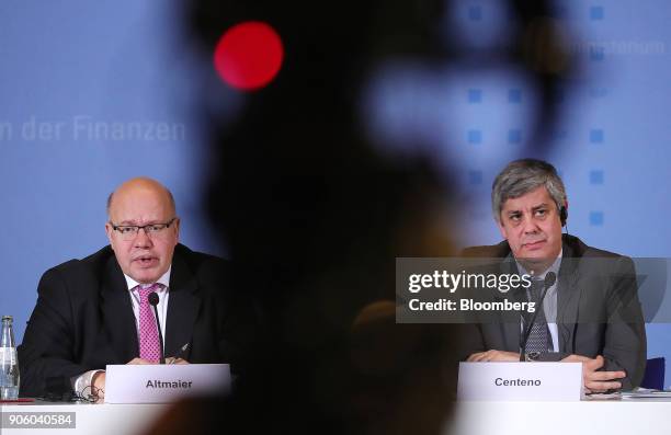 Peter Altmaier, Germanys acting finance minister, left, speaks as he sits beside Mario Centeno, Portugal's finance minister and head of the group of...