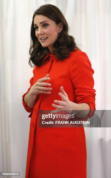 Britain's Catherine, Duchess of Cambridge gestures during her visit to officially open the Mittal Children's Medical Centre, home to the new Premier...