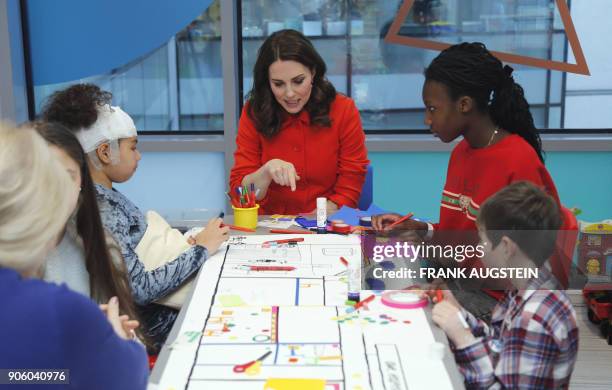 Britain's Catherine, Duchess of Cambridge speaks to patients during her visit to officially open the Mittal Children's Medical Centre, home to the...