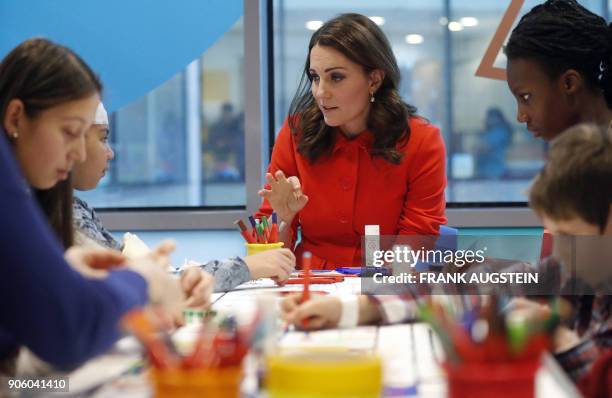 Britain's Catherine, Duchess of Cambridge speaks to patients during her visit to officially open the Mittal Children's Medical Centre, home to the...