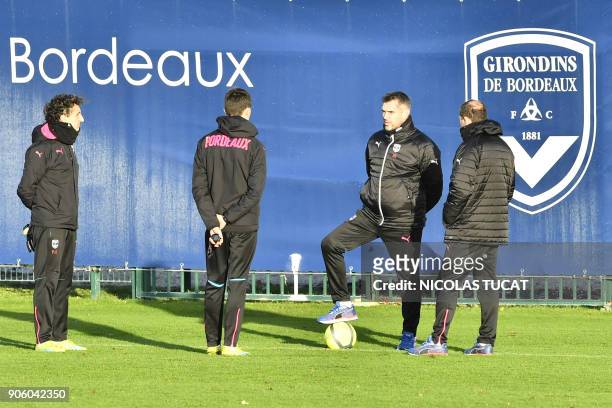 Bordeaux's French head coach Jocelyn Gourvennec talks with his staff members during a training session on January 17, 2018 at the Haillan training...