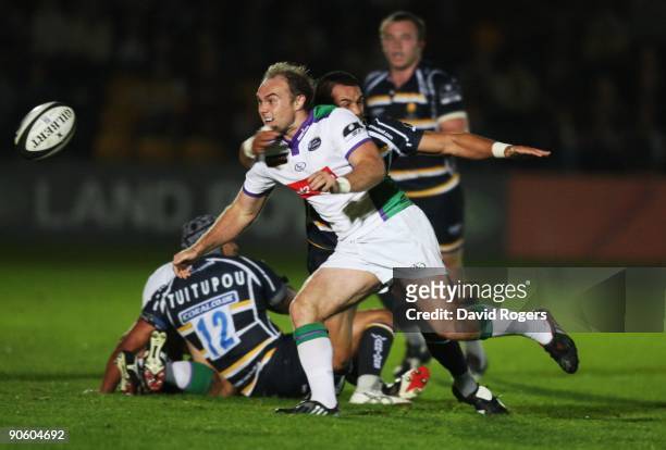 Ceiron Thomas of Leeds offloads the ball as he is tackled by Willie Walker of Worcester during the Guinness Premiership match between Worcester...