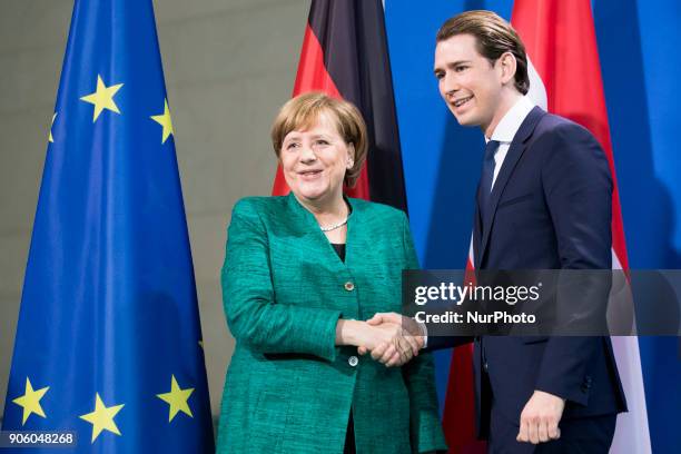 German Chancellor Angela Merkel and Austrian Chancellor Sebastian Kurz shake hands at the end of a press conference at the Chancellery in Berlin,...