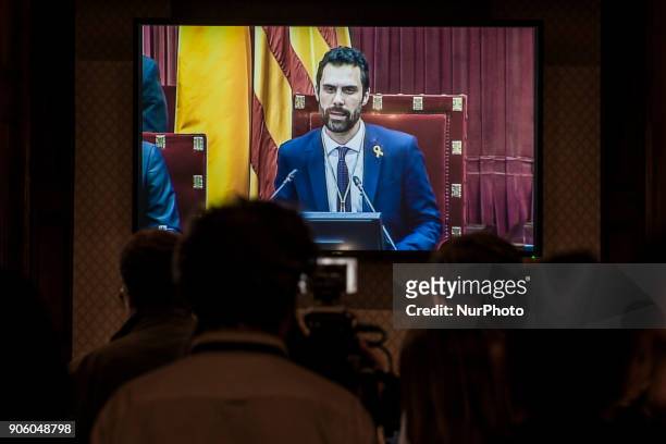 The new President of the Parliament of Catalonia, Roger Torrent, is followed by media in a screen during the constitution of the Parliament of...