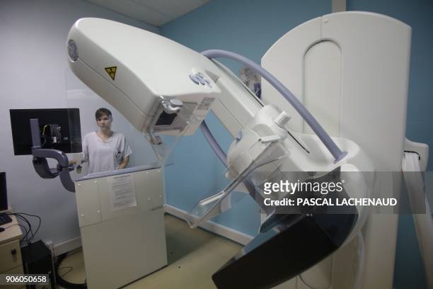 An operator stands by a high-end X-ray and mammography system, at the Gueret hospital, central France, on January 17, 2018. The inhabitants of the...
