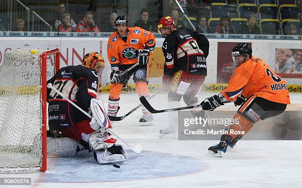 Kai Hospelt of Wolfsburg tries to score over goalkeeper Levente Szuper during the DEL match between Hannover Scorpions and EHC Wolfsburg at the TUI...