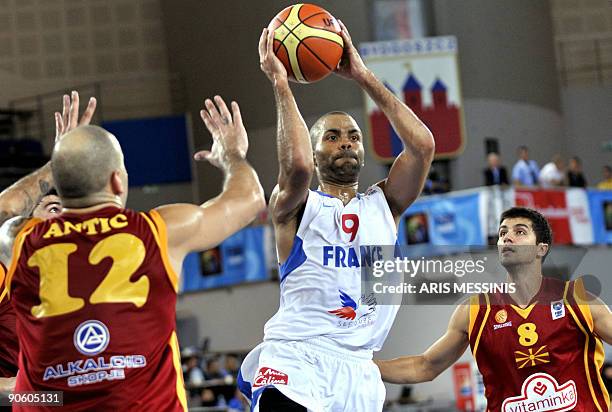 French Tony Parker is marked by Pero Antic of F.Y.R. Of Macedonia during a 2009 European championship qualifying round, group E, basketball game...