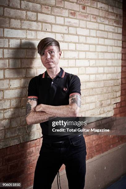 Portrait of American musician Jade Puget, guitarist with hard rock group AFI, photographed backstage before a live performance at Alexandra Palace in...