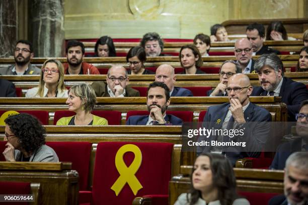 Roger Torrent, lawmaker with Esquerra Republicana de Catalunya , center, pauses before being invested as the new president of the Catalan parliament...