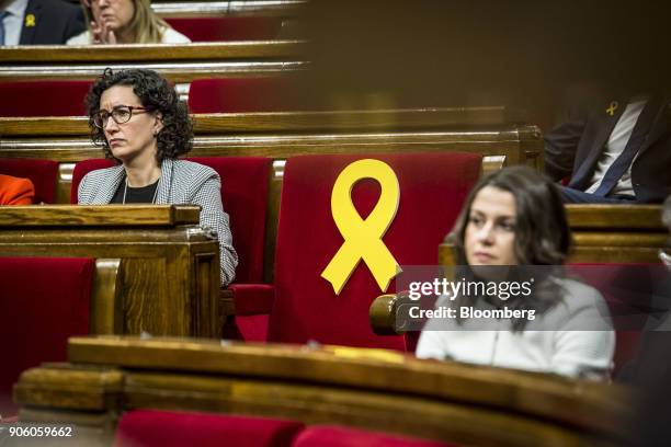 Marta Rovira, secretary general of Esquerra Republicana de Catalunya , left, and Ines Arrimadas, leader of Ciudadanos, sit beside a yellow ribbon...