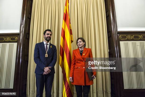 Roger Torrent, newly elected president of the Catalan parliament, left, stands besides Carme Forcadell, former president of the Catalan parliament,...