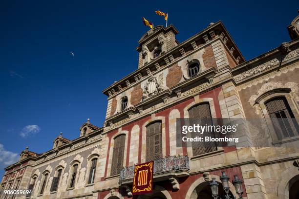 Spanish and Catalan flags fly above the Catalan parliament in Barcelona, Spain, on Wednesday, Jan. 17, 2018. Spanish Prime Minister Mariano Rajoy saw...