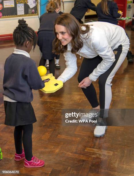 Catherine, Duchess of Cambridge, Patron of the All England Lawn Tennis and Croquet Club during plays a game with children during a visit to Bond...