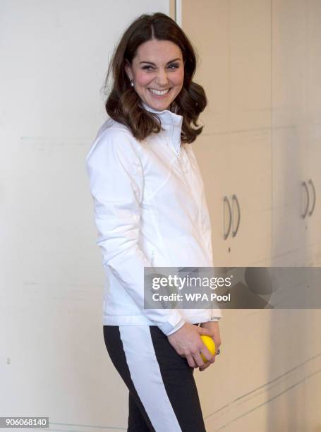 Catherine, Duchess of Cambridge, Patron of the All England Lawn Tennis and Croquet Club plays a game during a visit to Bond Primary School in Mitcham...