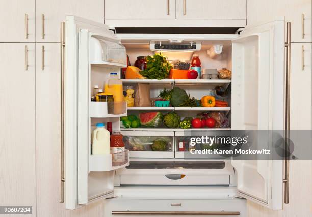 view of inside of refrigerator with healthy food - koelkast stockfoto's en -beelden