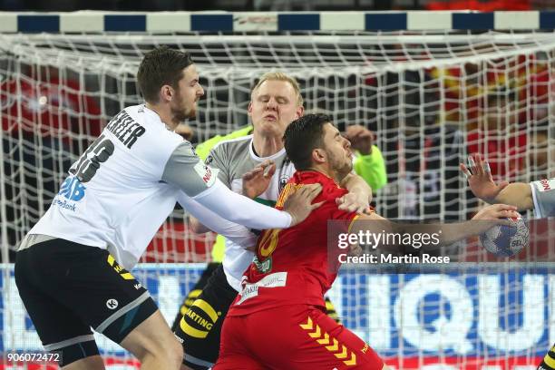 Filip Kuzmanovski of Macedonia is challenged by Hendrik Pekeler of Germany during the Men's Handball European Championship Group C match between...