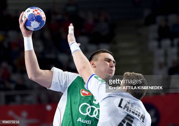 Hungary's Richard Bodo attempts to shoot on goal despite Czech Republic's Jan Landa during the group D match of the Men's 2018 EHF European Handball...