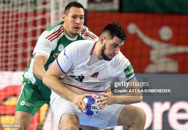 Czech Republic's Leos Petrovsky holds off Hungary's Timuzsin Schuch during the group D match of the Men's 2018 EHF European Handball Championships...