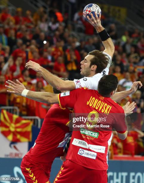 Uwe Gensheimer of Germany is challenged by Ace Jonovski of Macedonia during the Men's Handball European Championship Group C match between Germany...