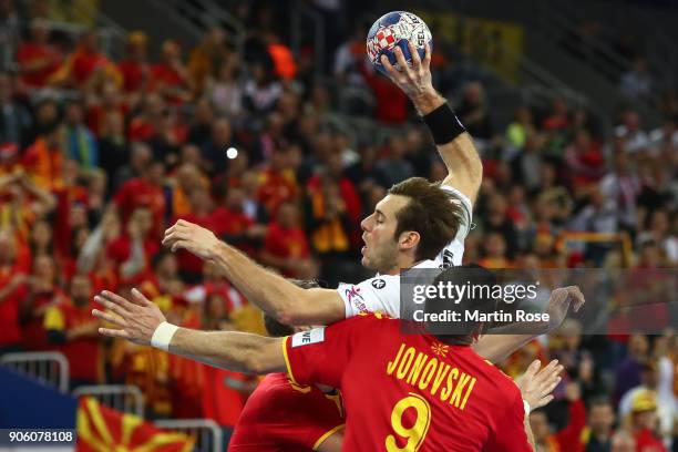 Uwe Gensheimer of Germany is challenged by Ace Jonovski of Macedonia during the Men's Handball European Championship Group C match between Germany...